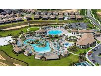 Aerial view of community pool, landscaping, and residential homes at 8979 Azalea Sands Ln, Davenport, FL 33896