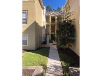 Exterior view of building showing walkway and landscaping at 413 Summit Ridge Pl # 305, Longwood, FL 32779