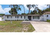 Newly renovated home with a modern facade and landscaped yard at 603 Conrad Dr, New Smyrna Beach, FL 32168