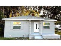 Newly painted gray house with white door, steps, and porch at 1416 34Th St, Orlando, FL 32839