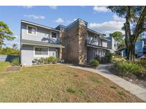 Attractive townhome with gray siding and brick accents, showcasing a well-maintained lawn at 707 Saint Matthew Cir, Altamonte Springs, FL 32714