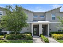 Modern 2-story townhome with attractive landscaping and a 2-car driveway at 820 Pebble Beach Dr, Davenport, FL 33896