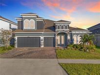 Two-story home with three-car garage and landscaped yard at 4408 Renly Ln, Clermont, FL 34711