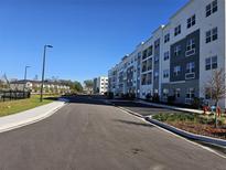 Modern apartment building with ample parking and landscaping at 1220 Southstation Pl # 102, Orlando, FL 32809