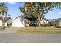 Cute one-story house with a two-car garage and well-maintained lawn at 2816 Oak Shore Rd, Oviedo, FL 32766