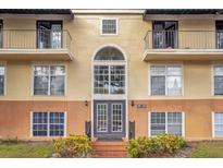 Condo building exterior featuring multiple balconies and a grand entrance at 3995 Versailles Dr # 3995F, Orlando, FL 32808