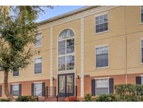 Tan building exterior with multiple windows and a central entrance at 4008 Versailles Dr # 4008C, Orlando, FL 32808
