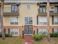 Inviting condo building entrance with landscaping at 4121 Dijon Dr # 4121H, Orlando, FL 32808