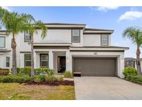 Two-story house with a two-car garage and landscaping at 4501 Monado Dr, Kissimmee, FL 34746