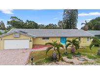 Ranch-style home with tile roof, attached garage, and landscaped yard at 10637 Deergrass Ln, Orlando, FL 32821