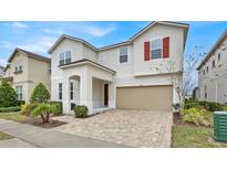 Two-story house with a two-car garage and a brick paved driveway at 1840 Caribbean View Ter, Kissimmee, FL 34747