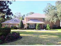 Brick home with landscaped yard and driveway at 772 Bear Creek Cir, Winter Springs, FL 32708