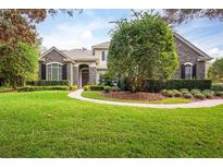 Stone exterior, lush landscaping, and a welcoming walkway at 3277 Lakeview Oaks Dr, Longwood, FL 32779