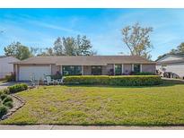 Single-story home with a well-maintained lawn and shrubs at 7022 Talbot Dr, Orlando, FL 32819