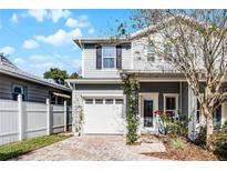 Gray two-story house with white garage door and landscaping at 225 E Grant St, Orlando, FL 32806