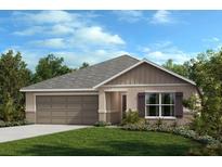 Single-story home with two-car garage and landscaped lawn at 3946 Axis Valley Pl, St Cloud, FL 34772