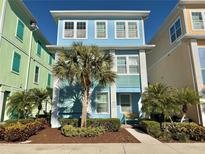 Beautiful two-story home with light blue exterior and palm trees at 8035 Surf St, Kissimmee, FL 34747
