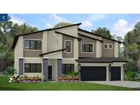 Two-story home with modern design, two-car garage, and landscaped front yard at 3921 Sonoma Blvd, Kissimmee, FL 34741