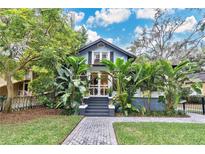 Charming bungalow with lush landscaping and a welcoming front porch at 1825 E Kaley Ave, Orlando, FL 32806