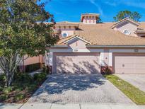 Two-story townhome with attached garage and paved driveway at 1300 Gilford Point Ln # 1300, Davenport, FL 33896