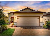 Attractive single-story home with a two-car garage and well-manicured landscaping at 541 Cantabria Dr, Davenport, FL 33837