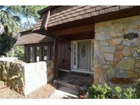 Inviting home exterior with stone accents and a wood-shingle roof at 306 Wild Olive Ln, Longwood, FL 32779