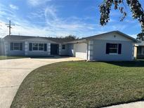 Newly renovated single-story home with a fresh coat of paint and landscaped lawn at 3522 E Kaley Ave, Orlando, FL 32806