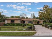 Charming single-story home with a split rail fence and landscaped yard at 1098 Park Dr, Casselberry, FL 32707