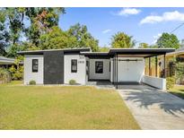 Modern home with white and black exterior, carport, and landscaped lawn at 1915 Weber St, Orlando, FL 32803