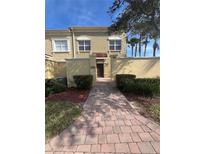 Inviting exterior with a paved walkway leading to the entrance of the home at 2404 Bella Vista Dr, Davenport, FL 33897