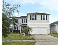 Two-story house with gray siding, white trim, and a two-car garage at 5427 Hanover Square Dr, St Cloud, FL 34771