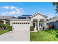 Two-story house with solar panels and a two-car garage at 842 Cherry Valley Way, Orlando, FL 32828