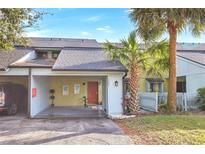 Front view of charming townhouse with carport and landscaping at 7484 Canford Ct # 8, Winter Park, FL 32792