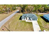 New construction home with landscaped yard and driveway at 14949 Sw 65Th Avenue Rd, Ocala, FL 34473