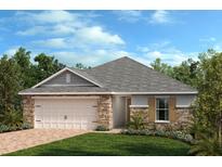 Attractive single-story home with stone accents, a two-car garage, and a landscaped front yard at 638 Meadows Edge Pl, Lake Wales, FL 33859