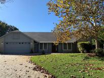 Gray house with two-car garage, and a neatly landscaped lawn at 9002 Calwood Ct, Orlando, FL 32825