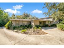 Ranch style home with a large front yard and mature trees at 7200 Grace Rd, Orlando, FL 32819