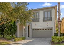 Two-story home with attached garage and landscaping at 1239 Radiant St, Reunion, FL 34747