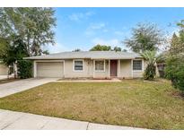 Single-story house with attached garage and well-maintained lawn at 127 Hidden Lake Dr, Sanford, FL 32773