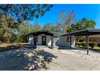 House exterior showcasing modern design and a carport at 2239 Crawford St, Mascotte, FL 34753