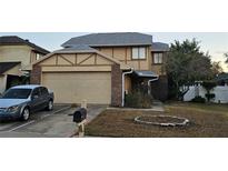 Charming two-story home with attached garage, landscaped yard, and white picket fence at 3563 S Saint Lucie Dr, Casselberry, FL 32707