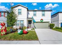 Two-story house with green garage door and festive holiday decor at 2362 Lancashire St, Davenport, FL 33896
