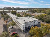 Aerial view of a condo building near the lake, showcasing ample parking and a waterfront location at 320 Lakeview St # 123, Orlando, FL 32804