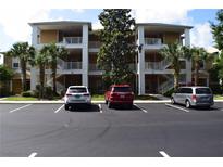 Attractive three-story condo building with balconies and parking lot at 605 Rum Run # 605, Davenport, FL 33837