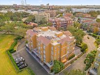 Aerial view of a multi-unit residential building near a lake and city at 7500 Toscana Blvd # 333, Orlando, FL 32819