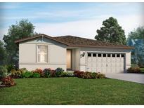 One-story home with a two-car garage and landscaped front yard at 1108 Griffon Ave, Lake Alfred, FL 33850