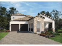 Two-story house with stone accents, two-car garage, and landscaped front yard at 16414 Silver Grove Blvd, Winter Garden, FL 34787