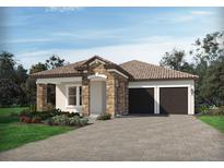 One-story home with stone accents, tile roof, and two-car garage at 16427 Silver Grove Blvd, Winter Garden, FL 34787