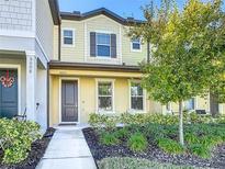 Well-maintained townhome boasts a charming exterior and landscaped front yard at 5006 Caspian St # 00, Saint Cloud, FL 34771