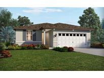 One-story house with a two-car garage and landscaped lawn at 788 Griffon Ave, Lake Alfred, FL 33850
